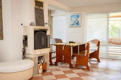 a living room with a table and a fireplace at Villa Beni - 4 Bedroom Private House by Flаt Manаger in Lozenets