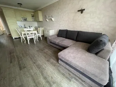 a living room with a couch and a table at Provence Deluxe Apartment in Atia Resort in Chernomorets
