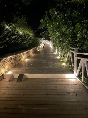 a wooden bridge with lights on it at night at Provence Deluxe Apartment in Atia Resort in Chernomorets