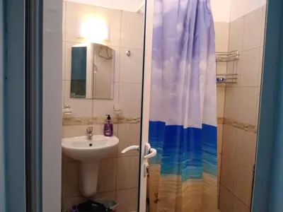 a bathroom with a sink and a shower curtain at The Blue Studio - In a complex next to the beach by Flаt Manаger in Pomorie