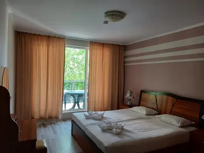 a bedroom with a bed with two bowls on it at Admiral Plaza Premium Apartments in Sunny Beach