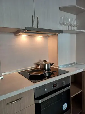 a kitchen with a stove with a pot on it at Admiral Plaza Premium Apartments in Sunny Beach
