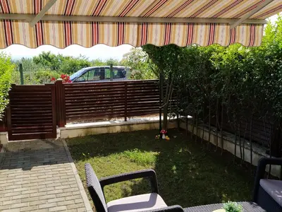 a patio with a fence and a table and chairs at Byala-apartment-valmira in Byala