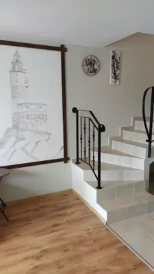 a room with stairs and a picture of a lighthouse at Byala-apartment-valmira in Byala