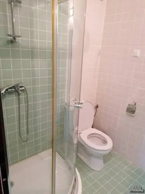 a bathroom with a toilet and a glass shower at Прекрасен апартамент с изглед към морето Сарафово 1 in Burgas City