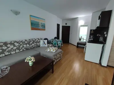 a living room with a couch and a table at Прекрасен апартамент с изглед към морето Сарафово 1 in Burgas City