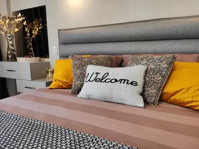 a bed with a pillow with the word welcome at студио Водолей in Obzor