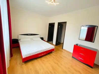 a bedroom with a bed and a red dresser at Long Sunny Holiday in Shkorpilovtsi