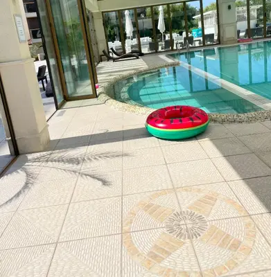 a red frisbee sitting on the ground next to a swimming pool at Long Sunny Holiday in Shkorpilovtsi