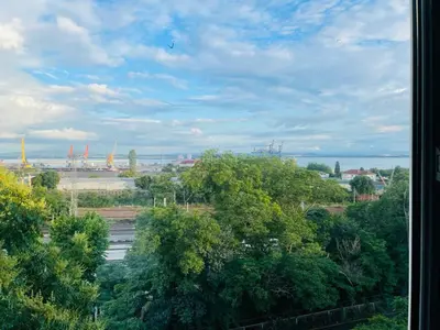 a view of a city from a window with trees at Апартамент Морски Изглед in Burgas City