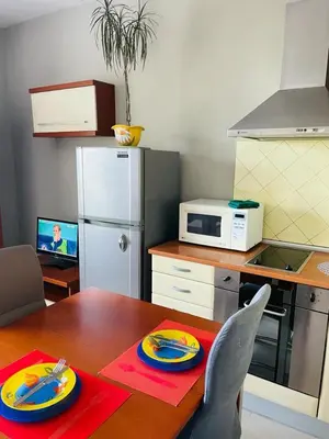 a kitchen with a wooden table with a dining room table sidx sidx sidx at Апартамент Морски Изглед in Burgas City