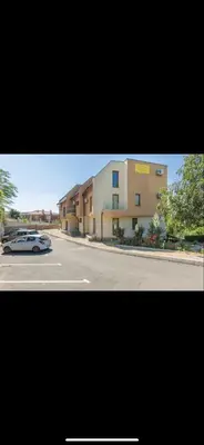 a car parked on a street next to a building at sea ​​view apartment Sozopol in Sozopol