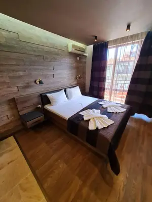 a bedroom with a bed with two towels on it at MitProt luks studio Panorama Bay 2 ap.105 in Sveti Vlas