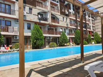 a hotel with a swimming pool in front of a building at MitProt luks studio Panorama Bay 2 ap.105 in Sveti Vlas