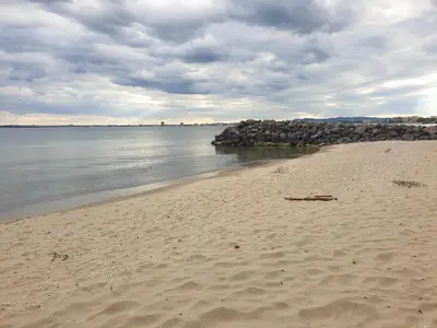 a beach with a bunch of rocks in the water at MitProt luks studio Panorama Bay 2 ap.105 in Sveti Vlas