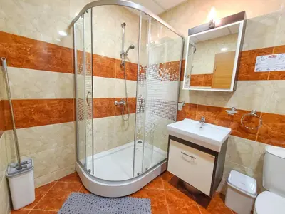 a bathroom with a shower and a toilet and a sink at Prestige Fort Aparthotel - Private apartment-BSR in Sveti Vlas