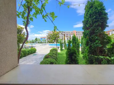 a view of a park with trees and a building at Prestige Fort Aparthotel - Private apartment-BSR in Sveti Vlas
