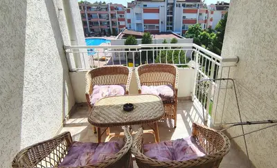 a balcony with two chairs and a table on a balcony at Sunny Fort Private Apartment in Sunny Beach