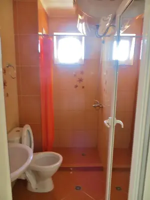 a bathroom with a toilet and a sink and a shower at Apartment in Azalia 2 complex in Nesebar