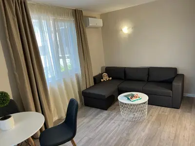 a living room with a couch and a table at Lotos Apartments in Kiten