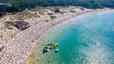 an aerial view of a beach with people and umbrellas at Lotos Apartments in Kiten