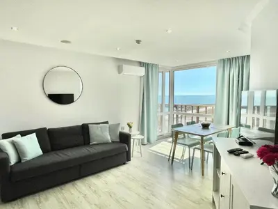 a living room with a couch and a table at Paradiso Aparthotel - Private apartment-BSR-1 in Nesebar