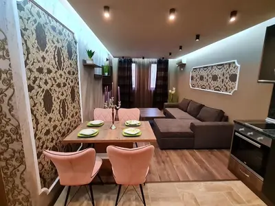 a living room with a table and chairs and a couch at MitProt Panorama Bay 2 luks apartment ap.73 in Sveti Vlas