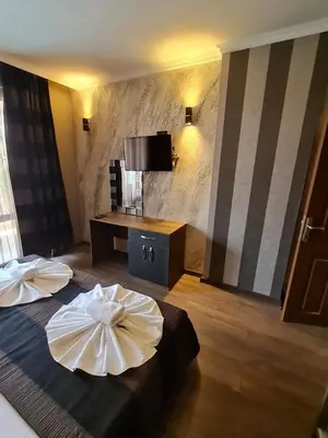 a hotel room with two beds and a television at MitProt Panorama Bay 2 luks apartment ap.73 in Sveti Vlas