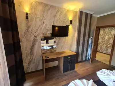 a room with a desk and a tv on a wall at MitProt Panorama Bay 2 luks apartment ap.73 in Sveti Vlas