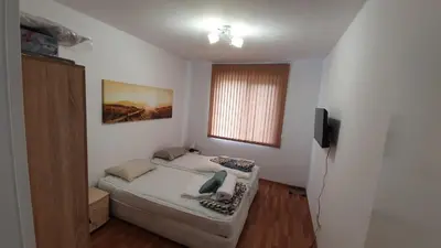 a small bedroom with a bed and a window at Pomorie Beach Resort in Pomorie