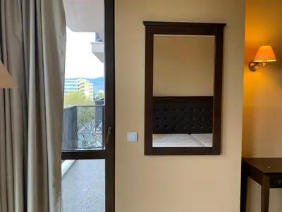 a mirror on a wall next to a window at Royal Beach Apartament Hotel in Sunny Beach