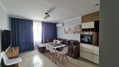 a kitchen and living room with a couch and a table at Apartment on the beach Ravda in Ravda