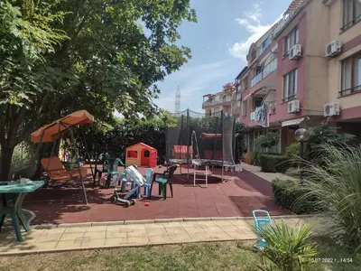 a patio with chairs and a table and a building at Апартамент на къмпинг Градина in Chernomorets