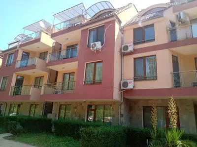a pink building with balconies on it at Апартамент на къмпинг Градина in Chernomorets