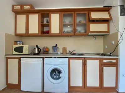 a kitchen with a washing machine and a microwave at ANITA A3 Cosy Studio SUNNY BEACH in Sunny Beach