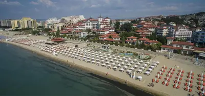 a beach with a lot of umbrellas and a city at ANITA A3 Cosy Studio SUNNY BEACH in Sunny Beach
