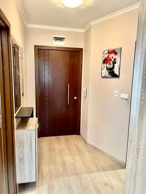 a hallway with a wooden door in a house at 3 стаен апартамент идеален център Варна in Varna City