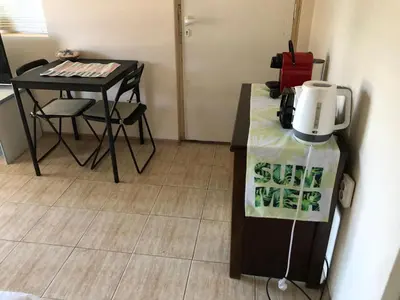 a room with a table and a coffee maker on a counter at Ssenyange Guest House in Varna City