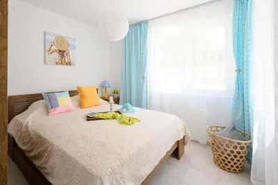 a bedroom with a bed and a window at Villa Baywatch in Galata