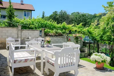 a white table and chairs on a patio at Villa Baywatch in Galata