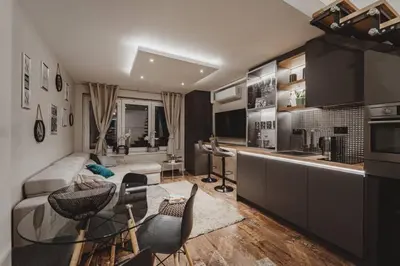 a kitchen and living room with a table and chairs at Sunset Apartment in Pomorie