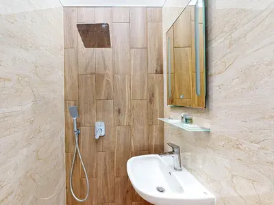 a bathroom with a sink and a mirror and a shower at Markoni 2 in Burgas City