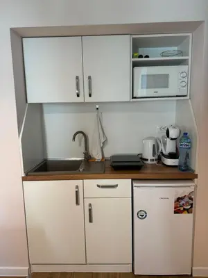 a small kitchen with a sink and a microwave at Markoni 2 in Burgas City
