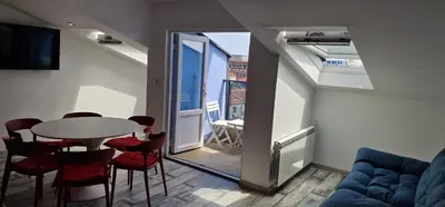 a living room with a table and chairs and a window at Seaman's house in Burgas City