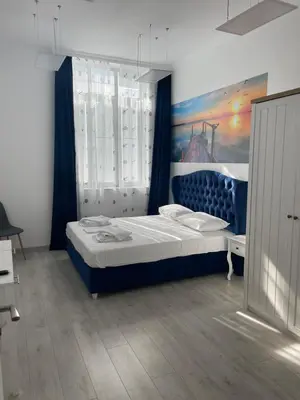a bedroom with a bed with a painting on the wall at Seaman's house in Burgas City