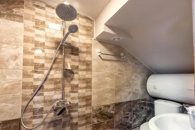 a bathroom with a shower and a toilet at BOLERO Suites in Varna City