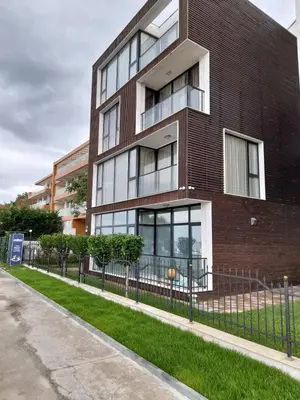 a brick building with a fence in front of it at AMARA-BOUTIQUE & DESIGN - Студио in Ravda