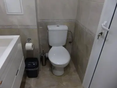 a small bathroom with a toilet and a sink at Apartament HOLIDAY in Burgas City