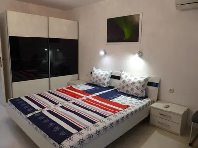 a bedroom with a bed with an american flag quilt at Apartament HOLIDAY in Burgas City