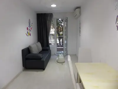 a living room with a couch and a table at Apartament HOLIDAY in Burgas City